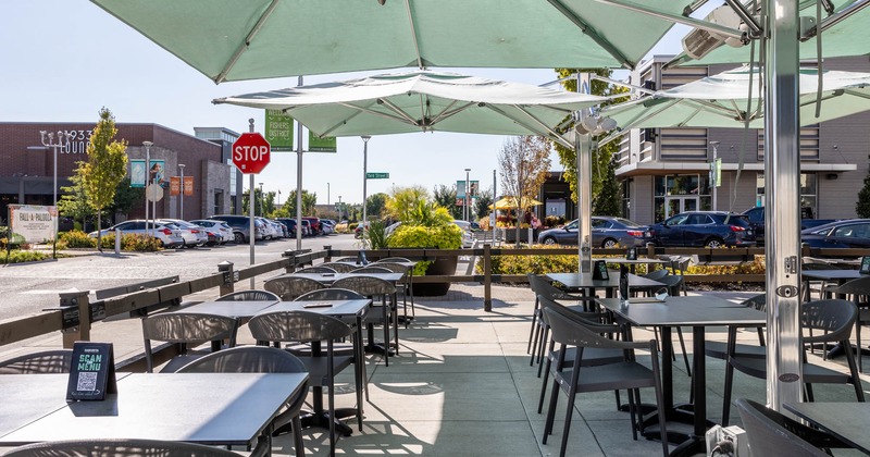 Exterior, patio, chairs and tables with the menus, wooden railing, parasols