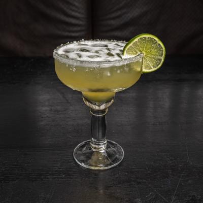 Margarita cocktail, garnished with lime wheel.