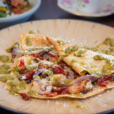 Shrimp crepe with green pesto sauce.