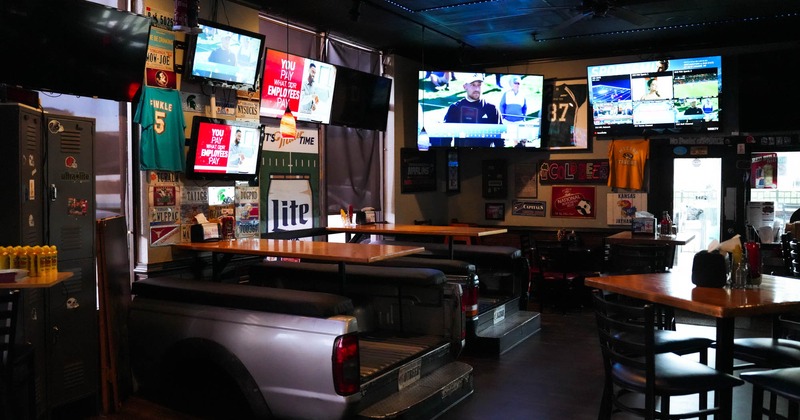 Interior, dining area, tv screens on the walls