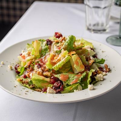 Fresh salad with romaine, cranberries, walnuts, and feta cheese.