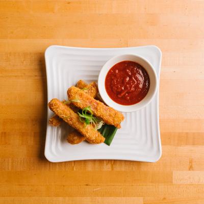 Spam fries served with red dipping sauce.