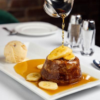 Butter Cake with Bananas Foster served with a scoop of ice cream.