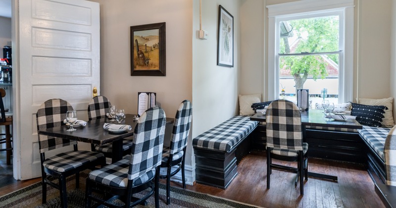 Interior, dining space with benches, tables in chairs in black and white plaid