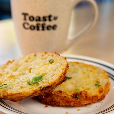Jalapeno Cheddar Biscuit with coffee in a branded mug.