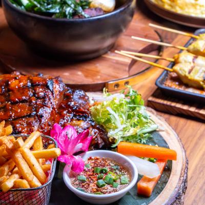 Grilled Rib - Eye Steak plate and other food dishes.