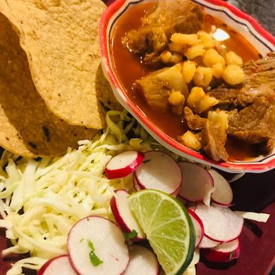 Mexican stew served with corn tortillas,  cabbage, and radishes.