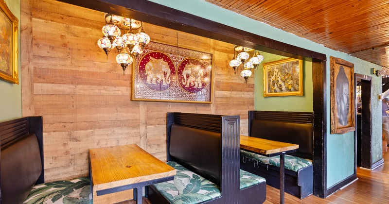 Cozy restaurant booths with decorative lamps and framed artwork