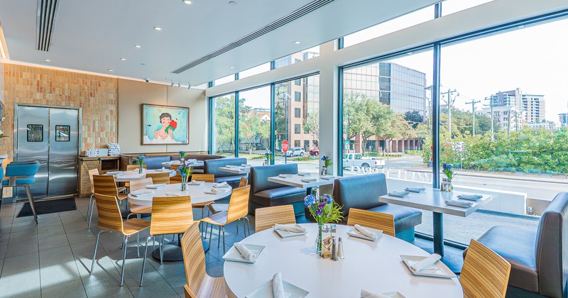 Modern and cozy interior dining area with set dining tables