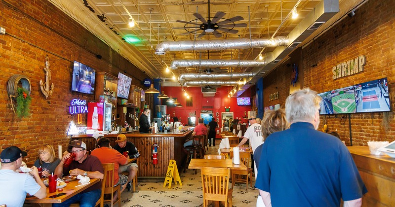 Interior space, bar area, and dining area with guests enjoying their food