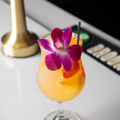 A drink with a flower and a straw.