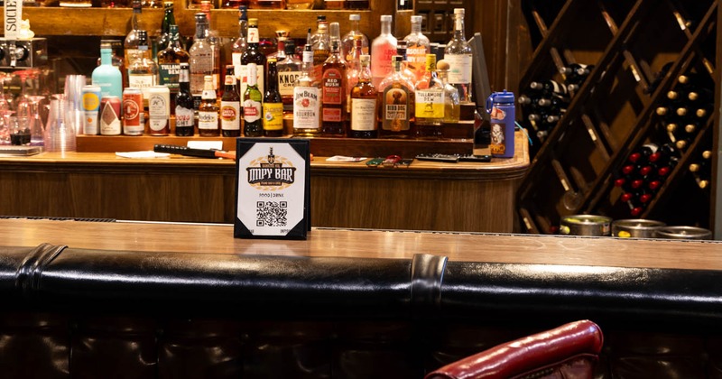 Bar counter and liquor bottles in the back bar, close up