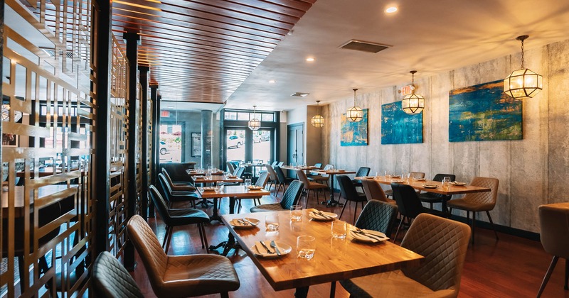 Interior, wide view, tables and chairs, pictures on the wall