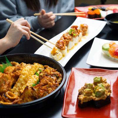 Diners enjoying a meal at a table with multiple food plates.