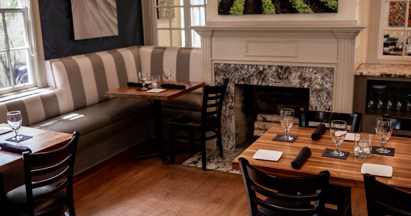 Interior, set tables and seating by fireplace
