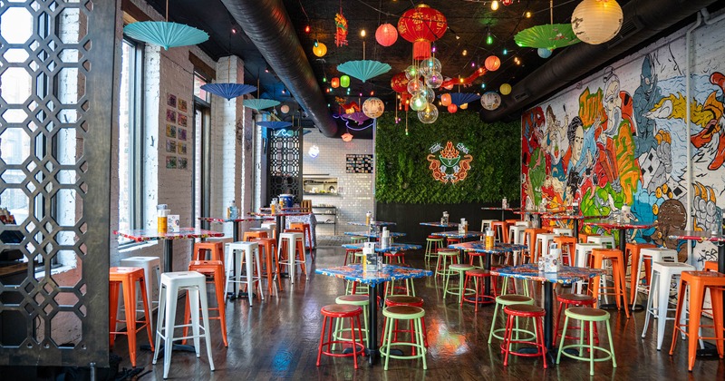 Interior, dining area with chairs, tables and colorful chandeliers