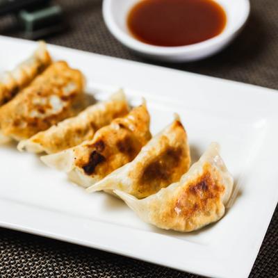 Pan-fried pork dumplings and dipping sauce.
