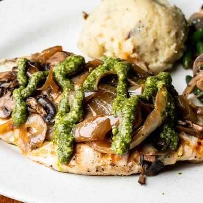 Grilled chicken breast, with grilled onions, mushrooms, and pesto sauce.