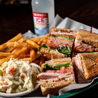 Check’s Club Sandwich with a side of fries and coleslaw.