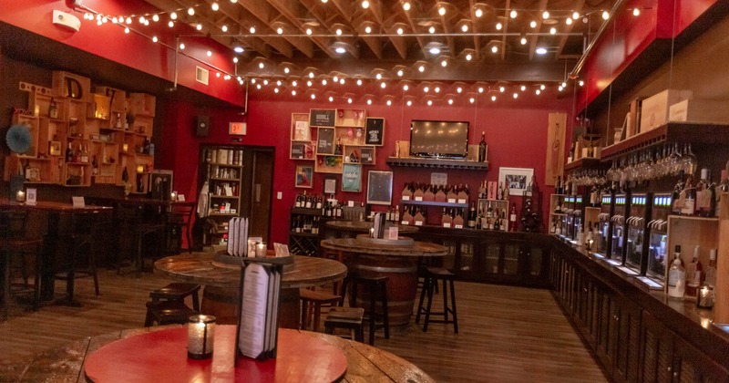 Interior, tables and seating, wines displayed by the walls, wall decorations