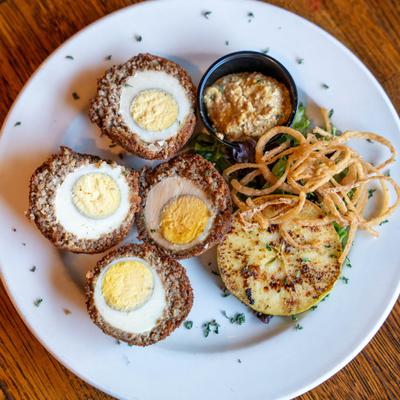 Scotch Eggs, fried onion straws, grilled apple, and spicy multi grain mustard.