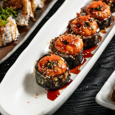 Spicy sushi rolls on a plate.