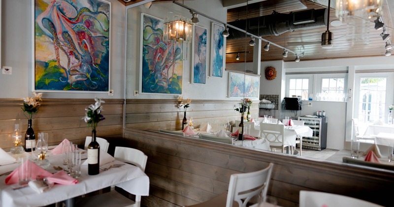 Interior, dining area, framed pictures and big mirror on the wall