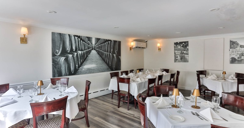 Interior, dining area, tables for ten, six and four people, various printed photos on the wall