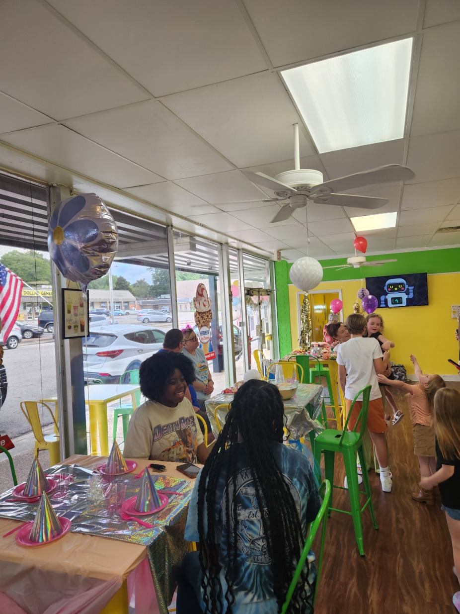 Interior with lime green and yellow walls and various birthday party decorations.