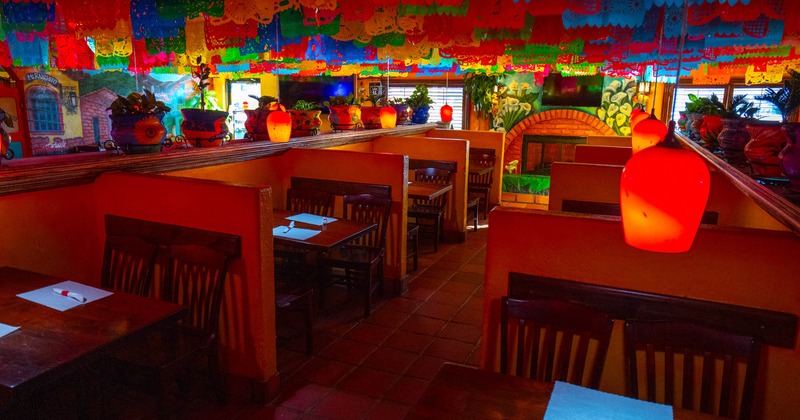 Interior, dining area, tables and chairs ready for guests, colorful Mexico inspired decoration