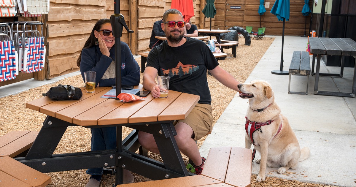 People outside on the patio with their pet