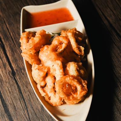 Fried calamari served with a dipping sauce.