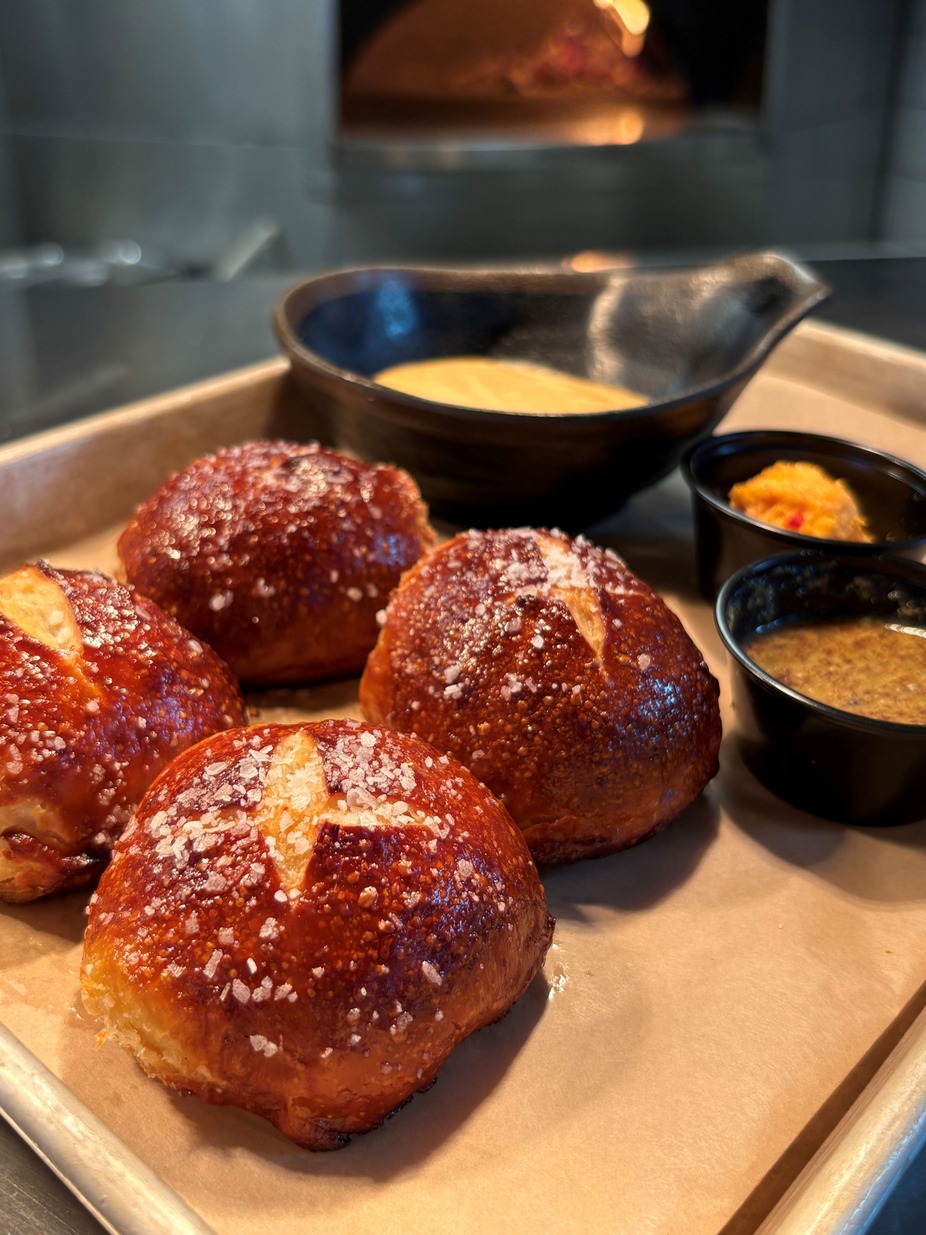 Pretzel Beer Rolls – Warm, house-made pretzel rolls baked with our craft-brewed beer, topped with sea salt and served with rich, creamy pimento cheese butter, beer cheese, and mustard.

*AVAILABLE EVERYDAY*