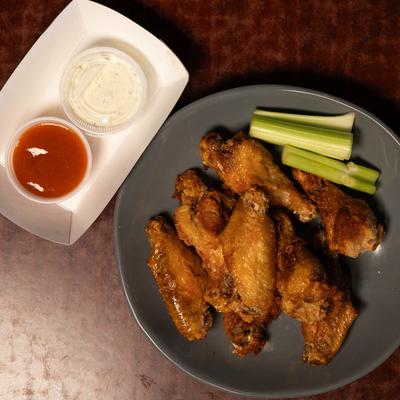 Wings served with celery and sauces.