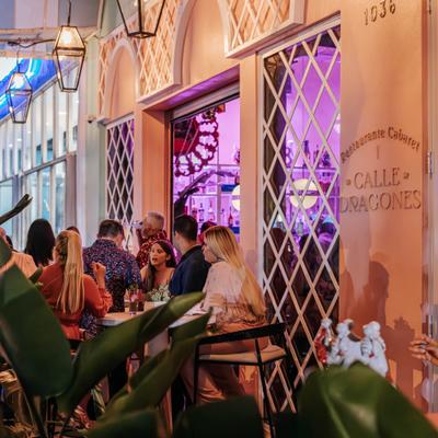 Calle Dragones terrace with guests seated.