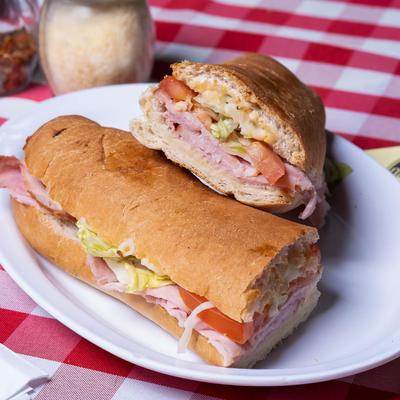 Ham sandwich with lettuce, tomato, mozzarella, and Italian dressing.