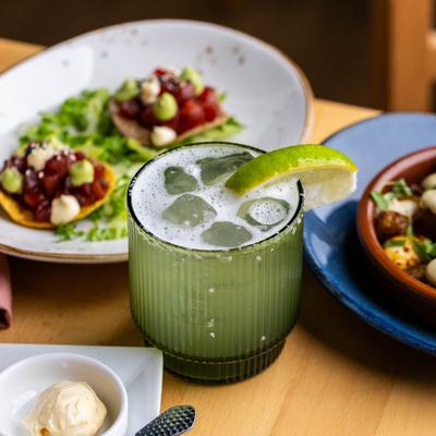 Margarita cocktail with tuna tostadas in the background.