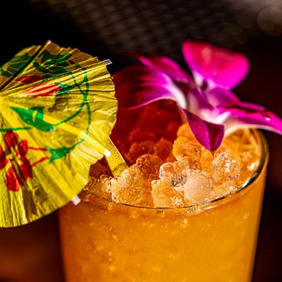 Low Low Luau cocktail garnished wih flower and an umbrella.