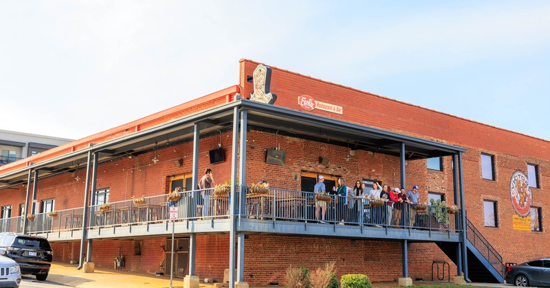 Exterior featuring a red brick building and features a second-story balcony overlooking the street