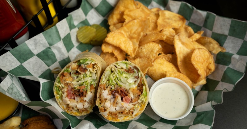 Chicken and Bacon Ranch Wrap with potato chips and a sauce