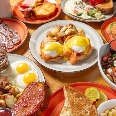 A table full of different food plates.