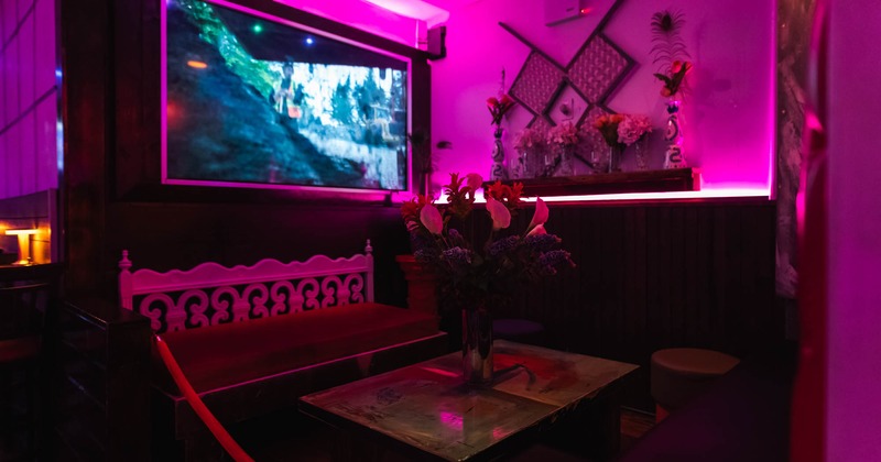 Interior, corner seating, divan bench with coffee table, various flower decoration