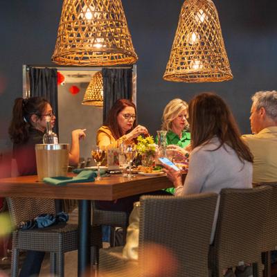 People seated at a table under warm lighting.