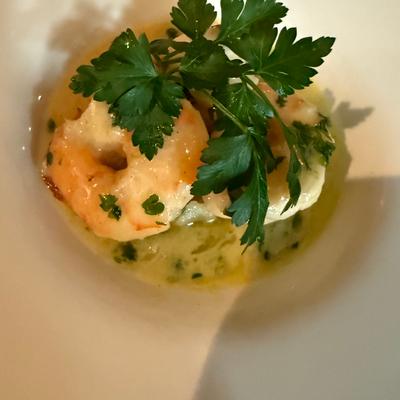 Garlic shrimp in white sauce with parsley garnish.