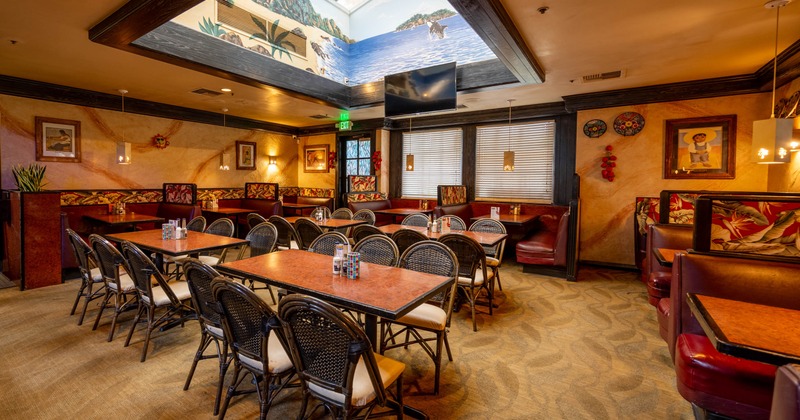 Interior, dining area, tables for six, seating booths in the back, carpet flooring