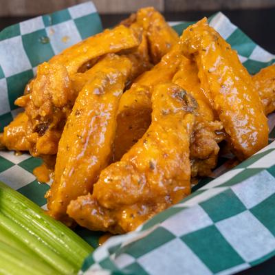 Buffalo wings with celery sticks and ranch for dipping.