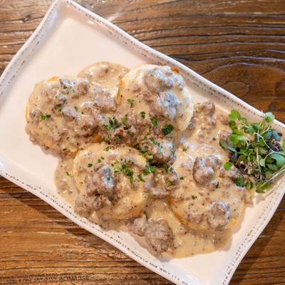 Two homestyle biscuits topped with house-made sausage gravy served with tater tots.