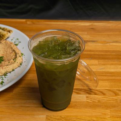 Mint lime refresher served in a plastic cup over ice.