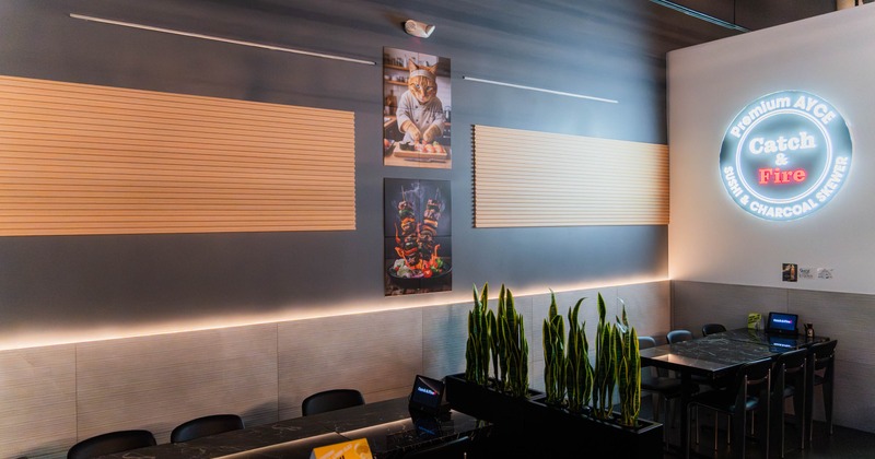 Interior - wooden slats, a neon sign, cat chef artwork.