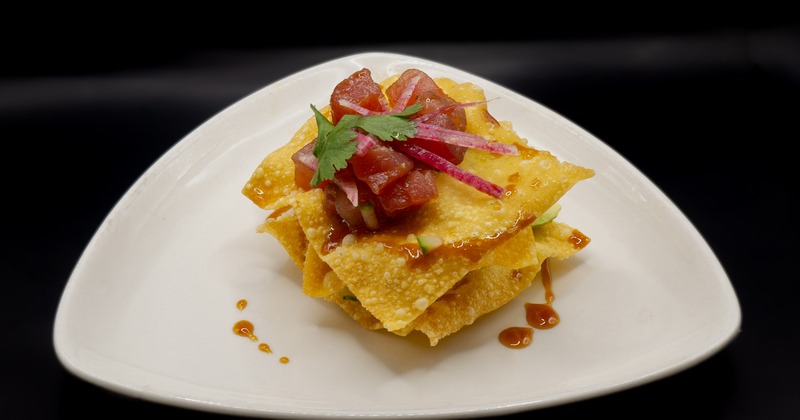 Ahi Tuna Tartare Wontons on a white triangular plate